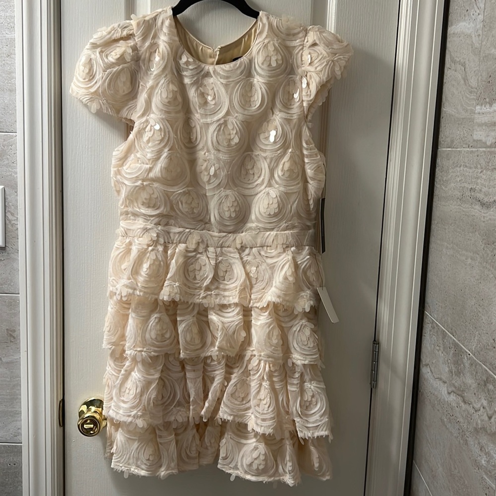 Lulu’s Off-white beautiful dress. It’s tiered with flowers and sequin everywhere